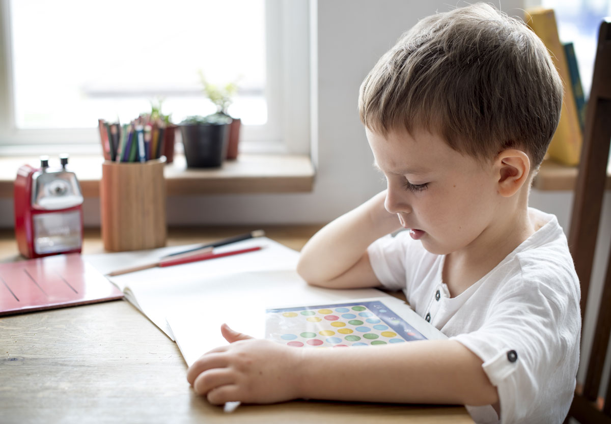 Boy using a picture communication board; augmentative and alternative communication therapy in El Paso